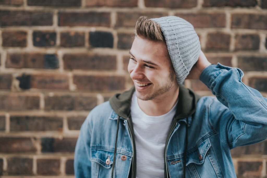supported-accommodation-young-man-smiling-with-grey-hat-and-blue-jacket
